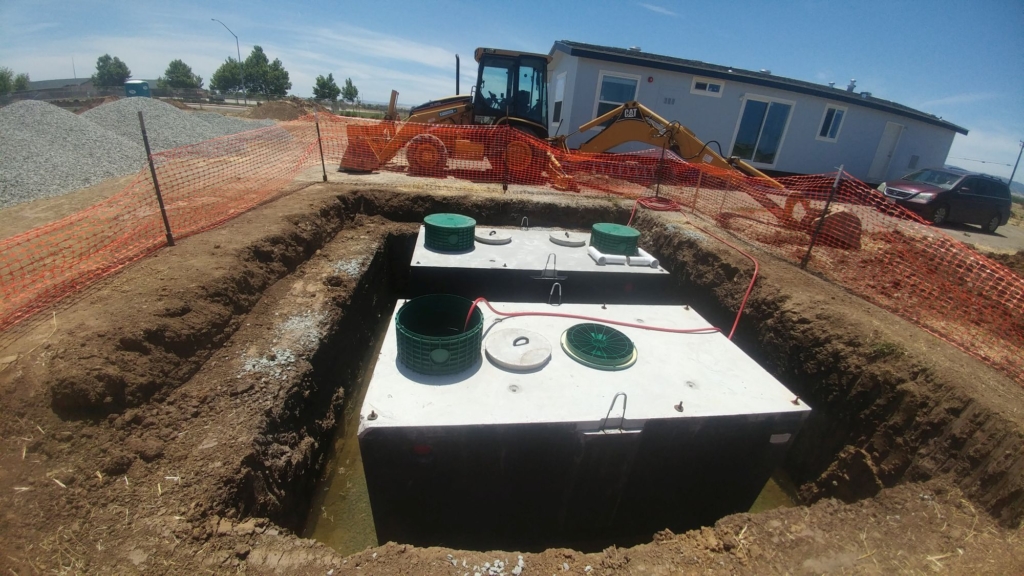 hose filling a 1500 gal septic tank in ground