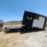 shed being offloaded from a trailer, tiled down