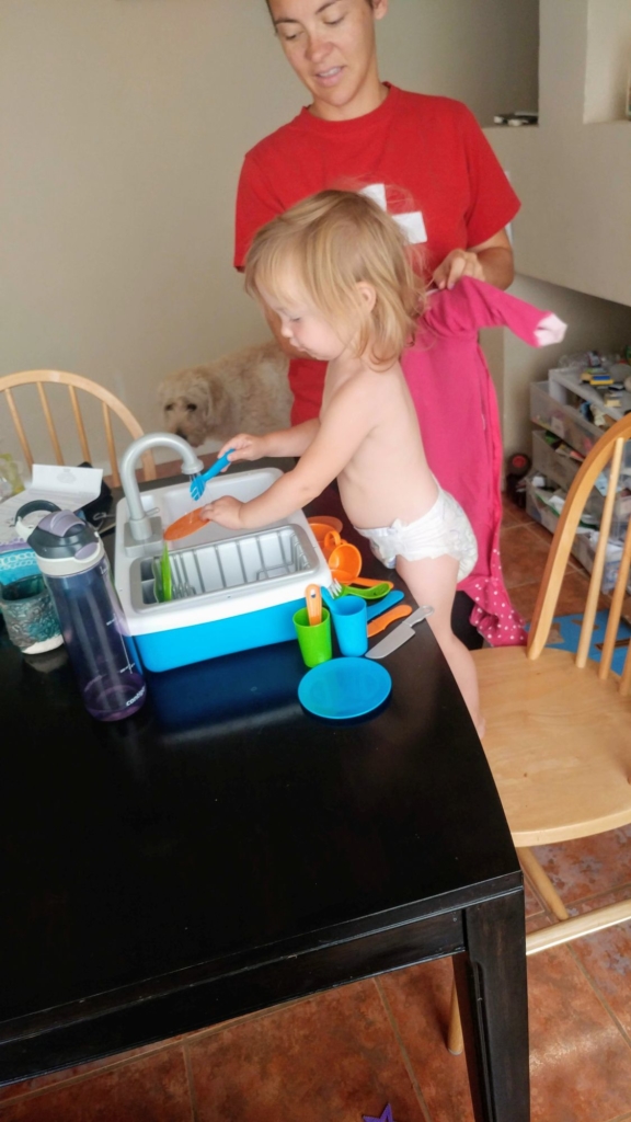 Child playing with a toy sink