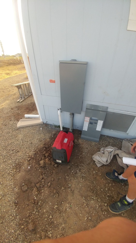 a red honda generator hooked up to an energy panel