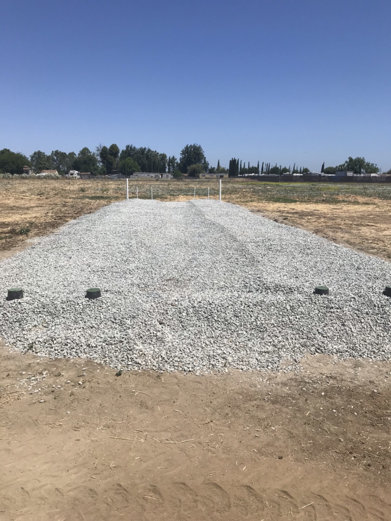 a large rocky field prepared for a septic system