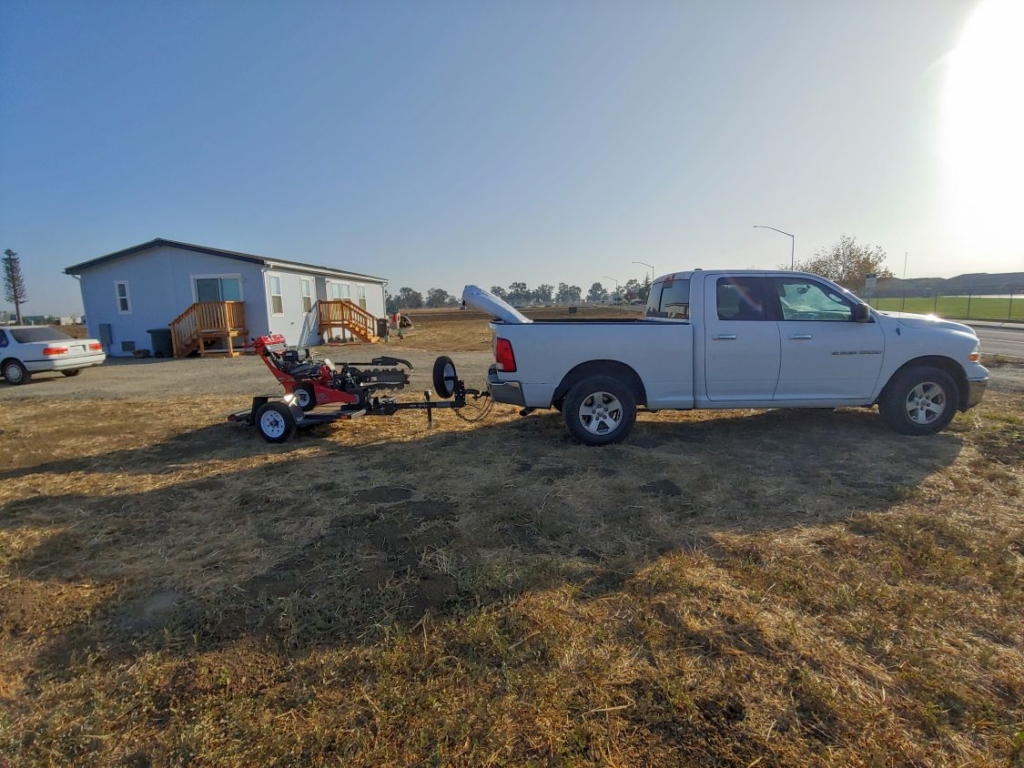 truck towing a ditch witch